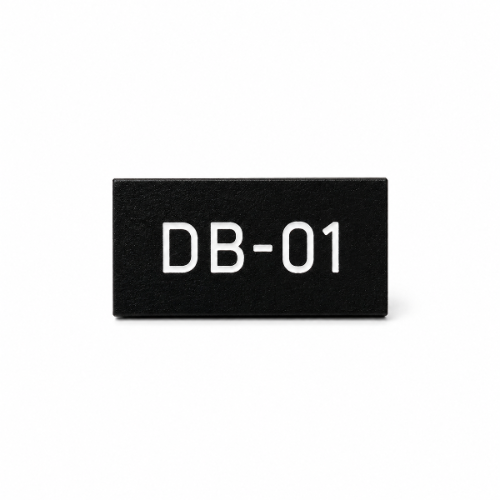 Black traffolyte label with white engraved DB-01 text