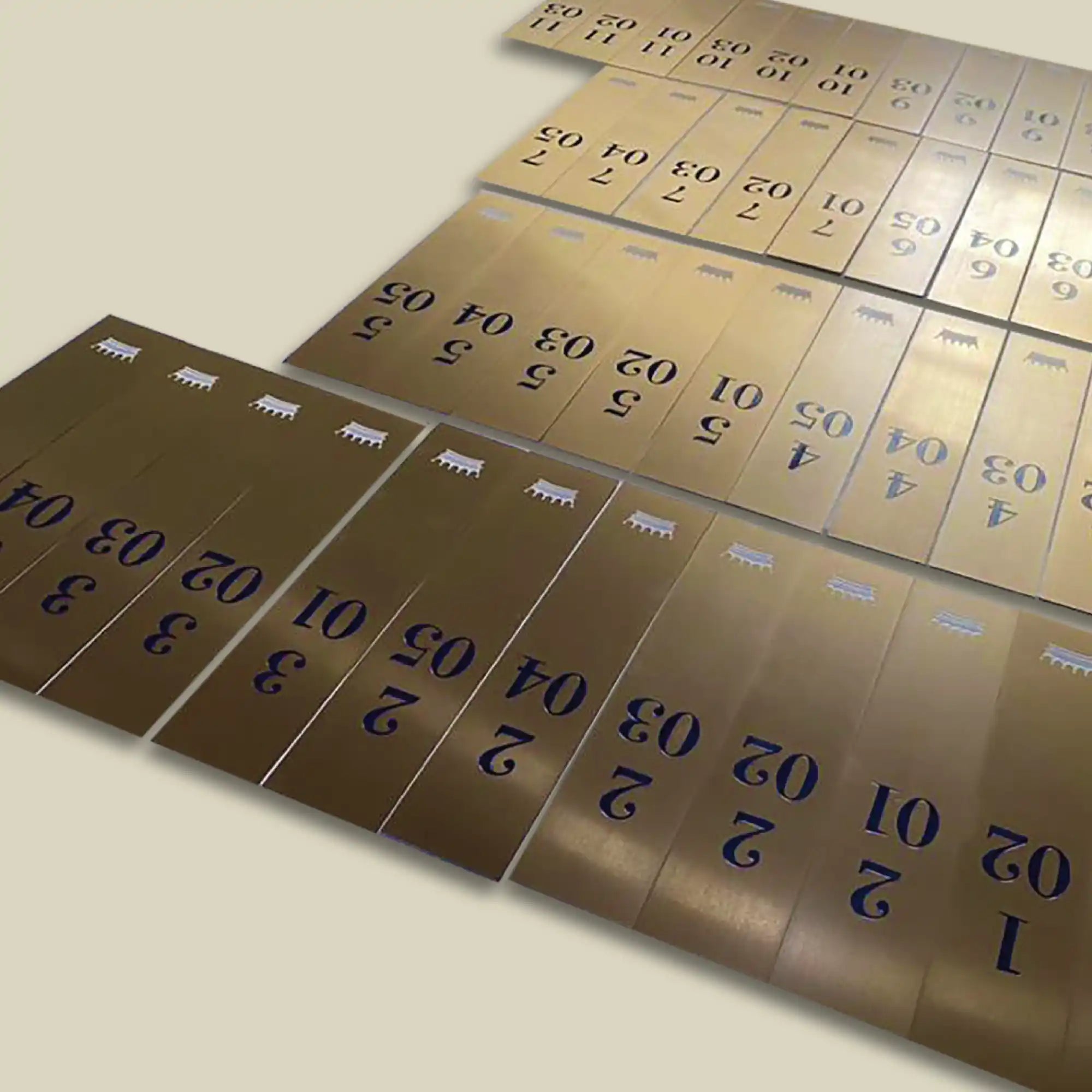 Rows of golden-colored metal strips with dark printed numbers.