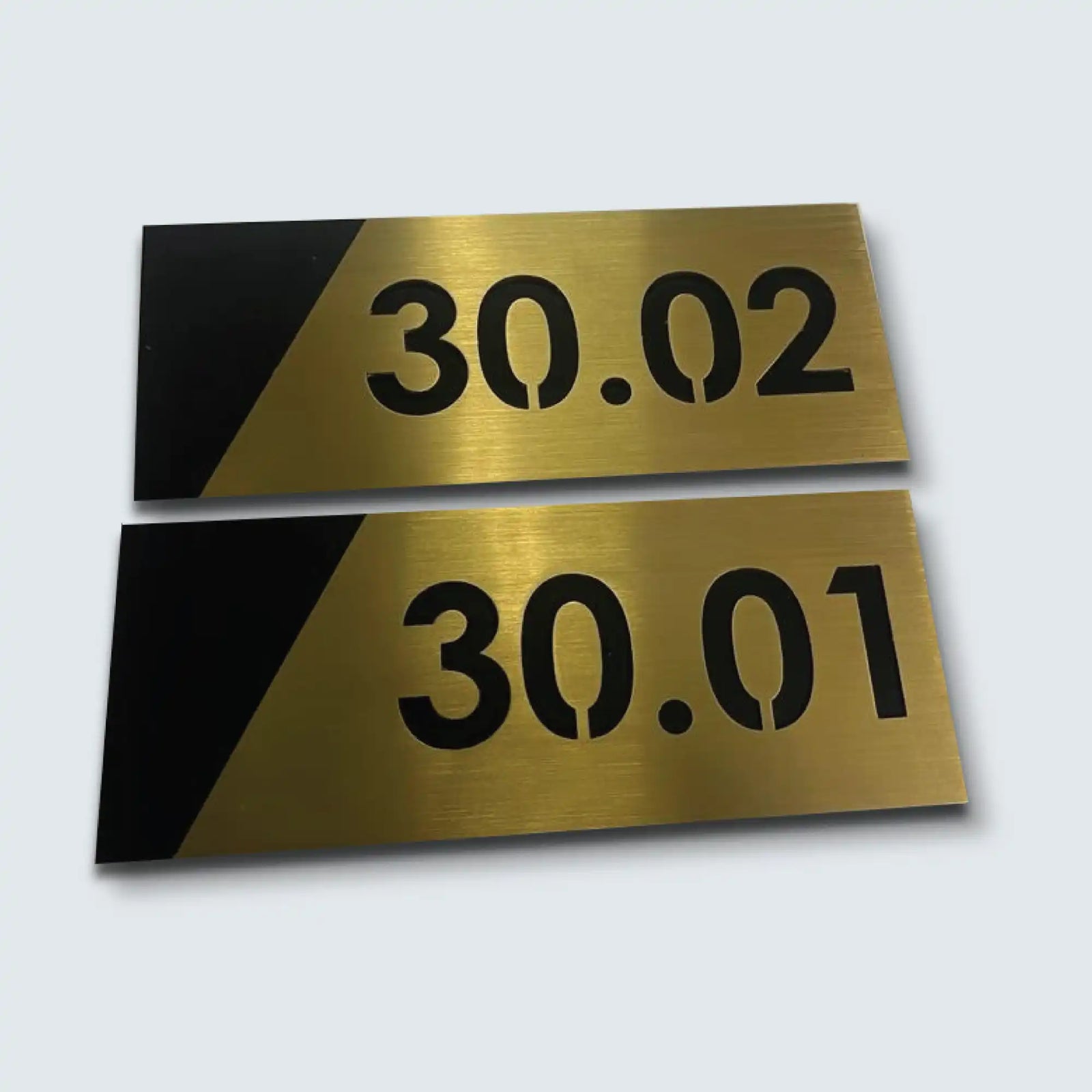 Brass and black room number signs